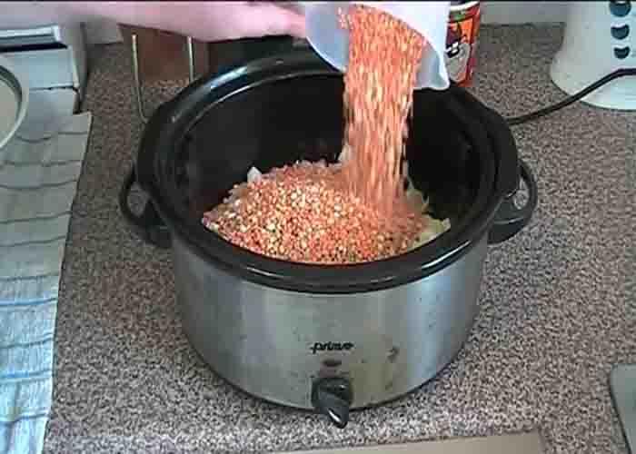 Adding in the mixed soup grains in the slow cooker