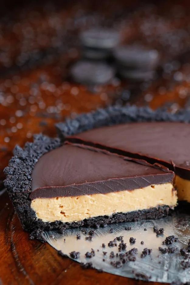 Peanut butter pie with a thick creamy peanut butter layer over chocolate in a dark cookie crumb crust