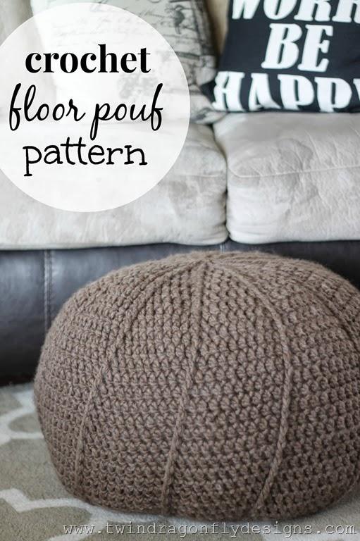 Round tan crochet floor pouf with raised vertical ribs sitting on a grey trellis rug in front of a leather sofa