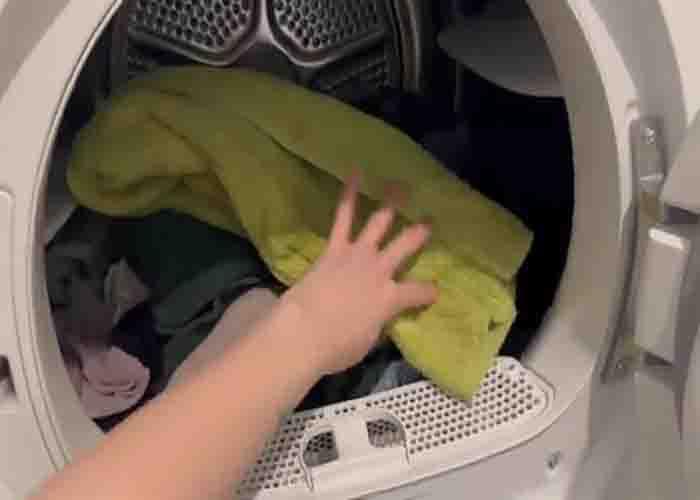 Adding the towel to the dryer