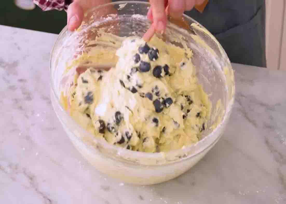 Mixing the batter with blueberries for the coffee cake
