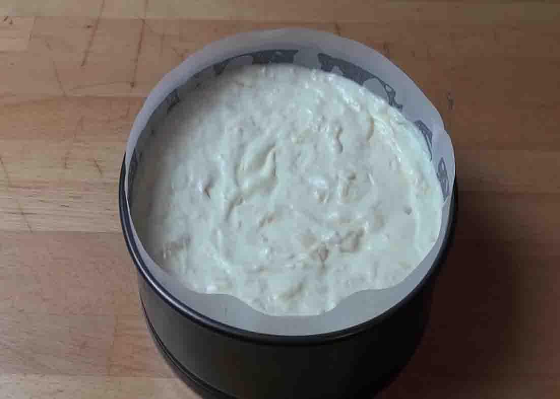 Transferring the pineapple cream cake mixture to the springform tin