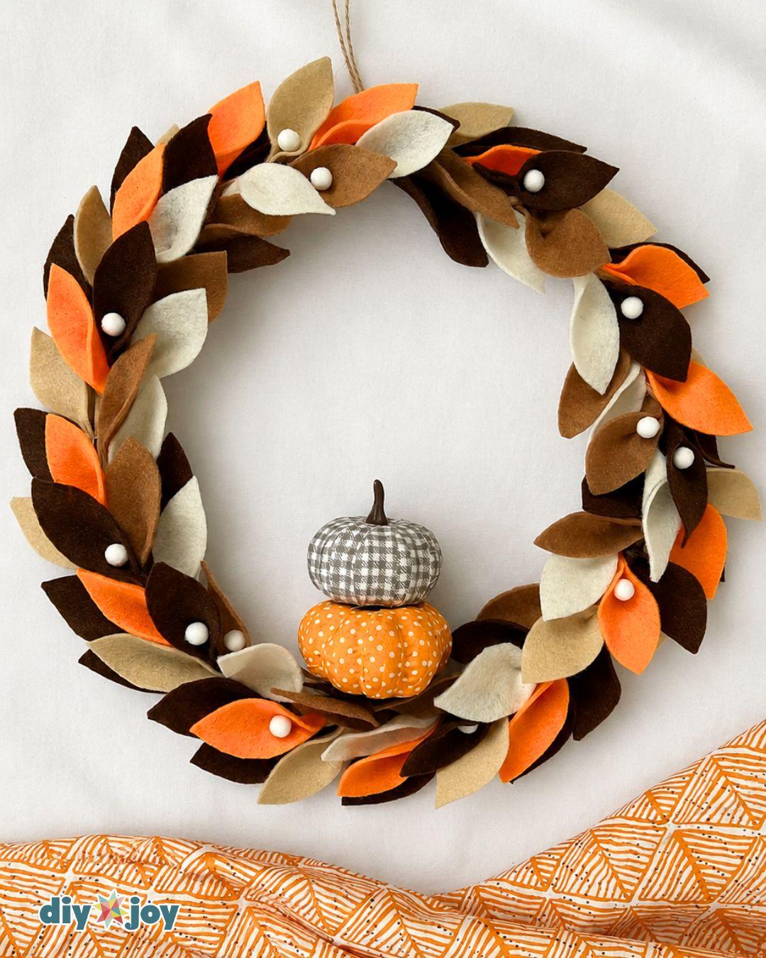 Felt leaf wreath for fall bringing together soft felt leaves in beautiful colors for a front door decoration.