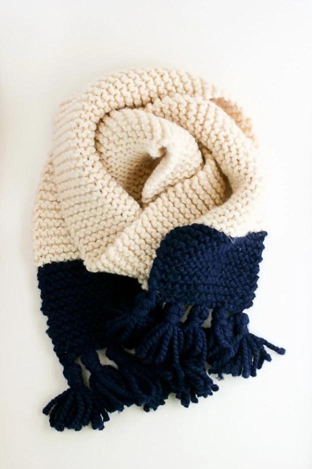 An elegant color block scarf finished with pom poms for a cozy handmade Christmas present for the whole family