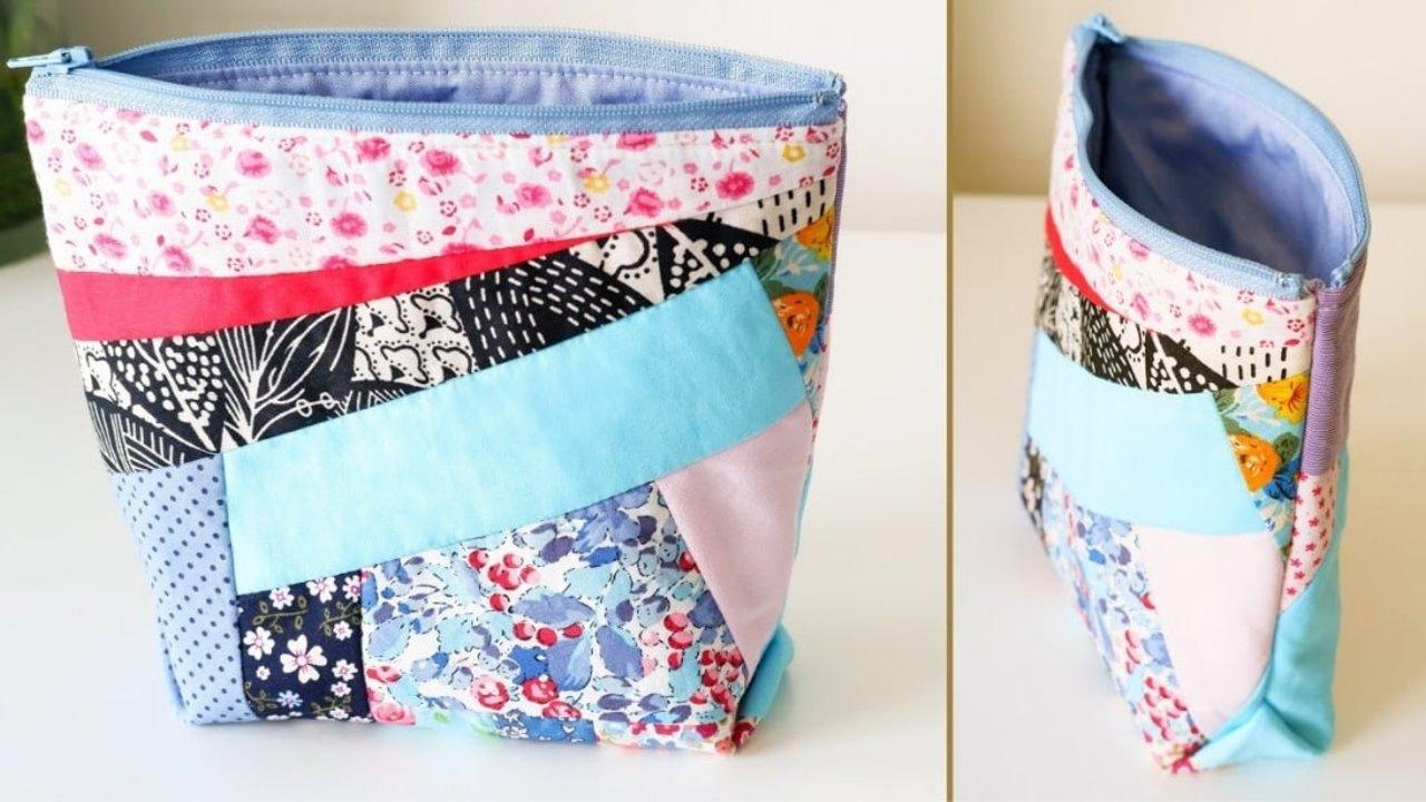 Quilted fabric scrap zipper pouch pieced from pink floral, aqua and black and white print scraps with a periwinkle lining