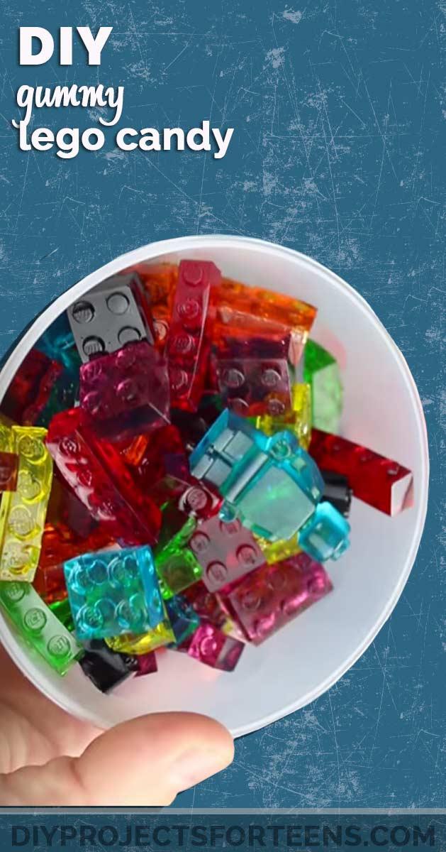 Gummy Lego candy, a white bowl of translucent red green blue and orange gummy building bricks held in one hand