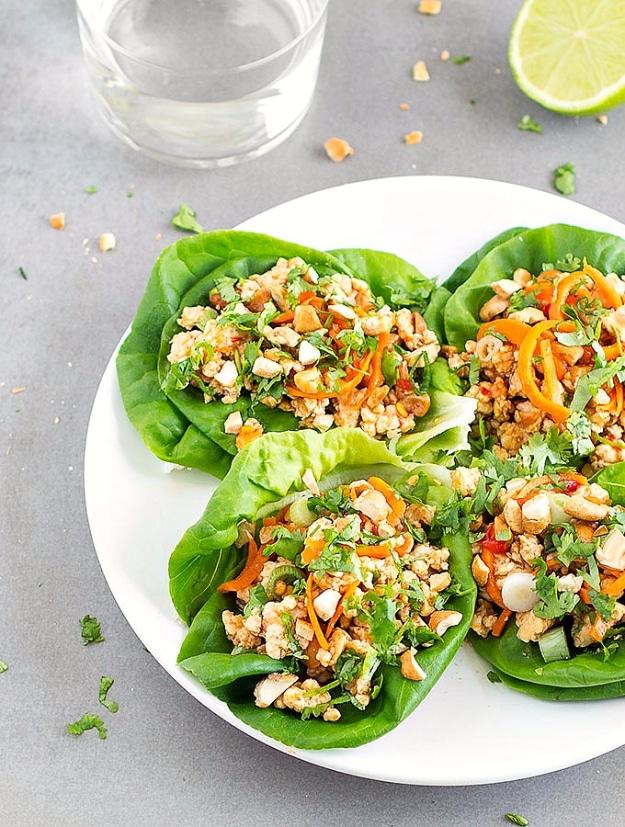 Healthy Asian chicken lettuce wraps in butter lettuce cups with cashews, carrots and cilantro for a fifteen minute dinner