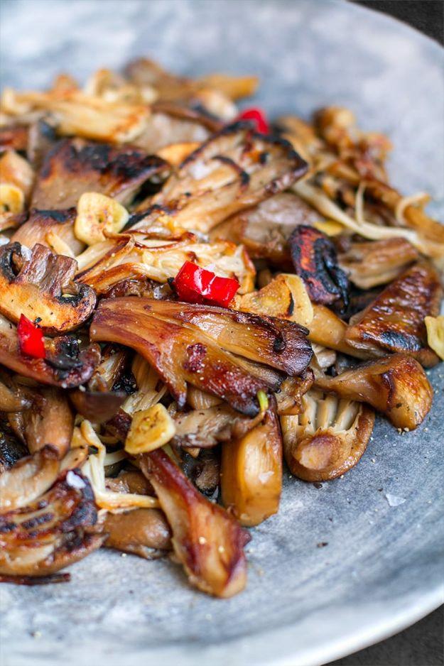 Garlic chilli mushrooms in a hot pan with shallots, red chilli and lemon zest, a gluten free appetizer idea