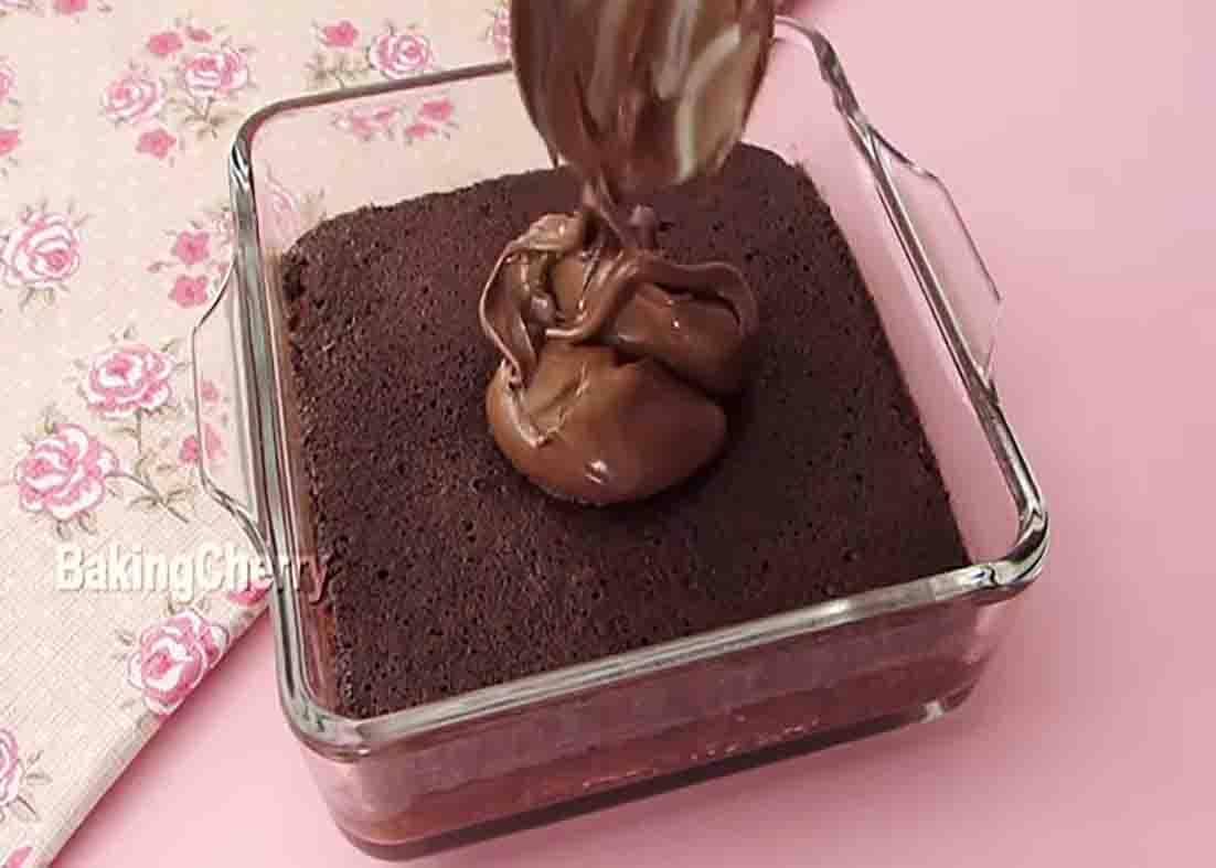 Spreading Nutella over the chocolate cake