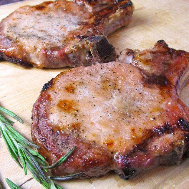 Oven baked bone-in pork chop with a browned brown sugar and paprika crust, resting beside a sprig of rosemary