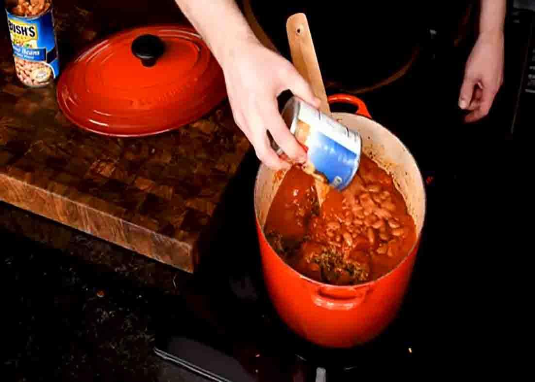 Adding the beans to the ground beef chili