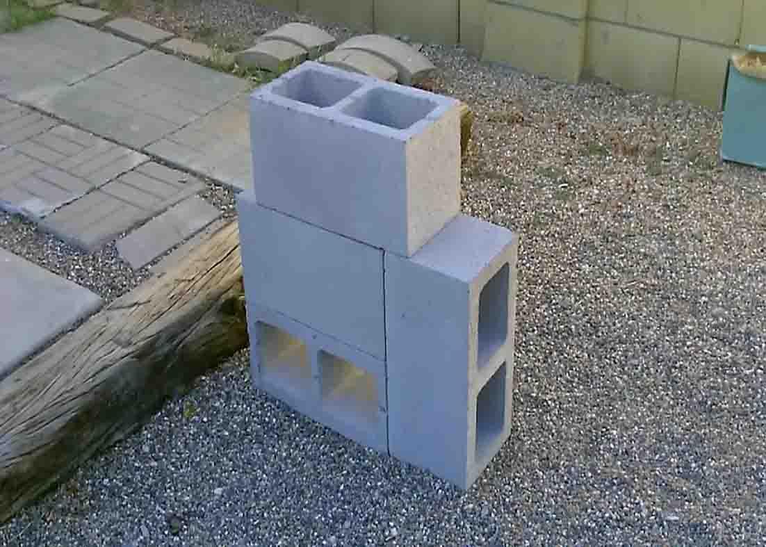 Assembling the cinder blocks to make the rocket stove