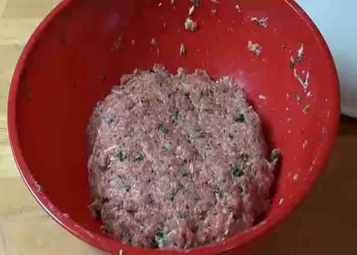 Combining all the ingredients for the crockpot meatballs