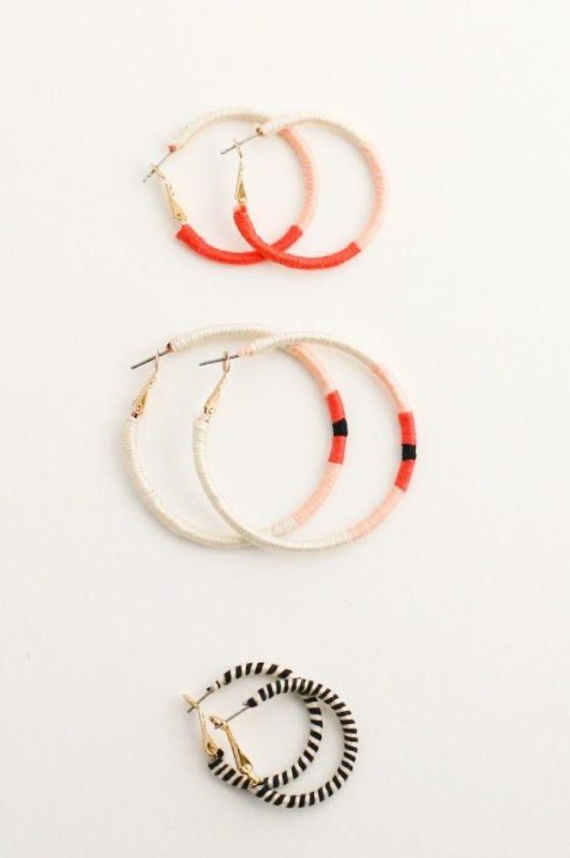Embroidery thread wrapped hoop earrings, five hoops wound in cream, coral, peach and black striped floss on white