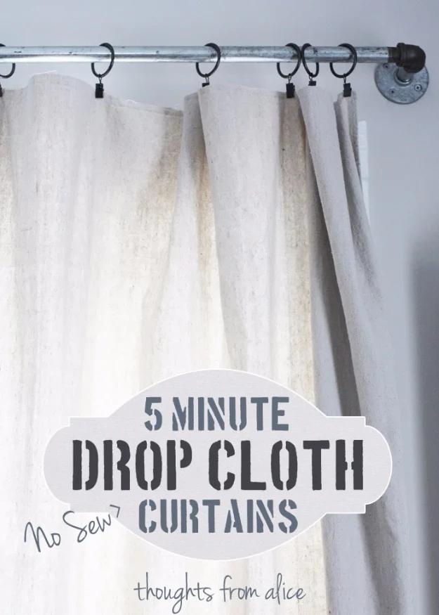 Canvas drop cloth curtains on black clip rings and a pipe rod, with a typeset 5 Minute Drop Cloth Curtains title