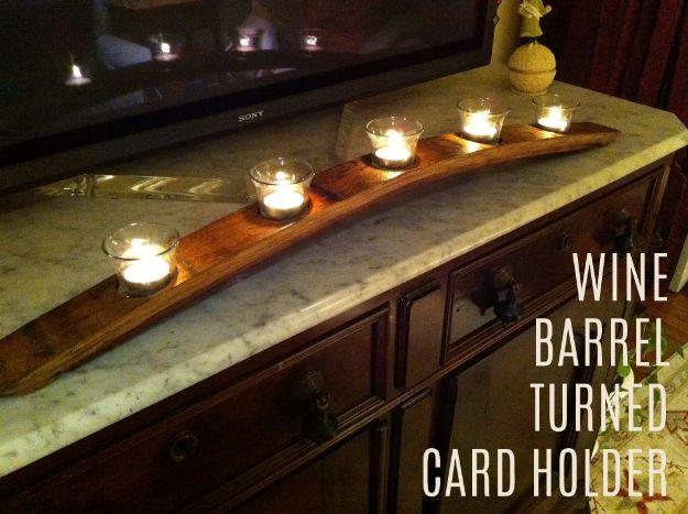 Wine barrel turned candle holder, a curved oak stave with five lit glass votives sitting on a marble topped dresser