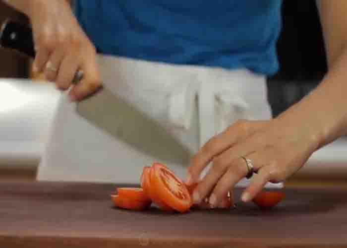 Chopping the tomatoes for the cowboy caviar salsa