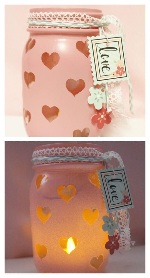 Small mason jar votives wrapped in lace and twine holding tea lights down a Valentine's table for a handmade gift