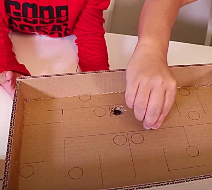 Make a cardboard maze game that is played with marbles.