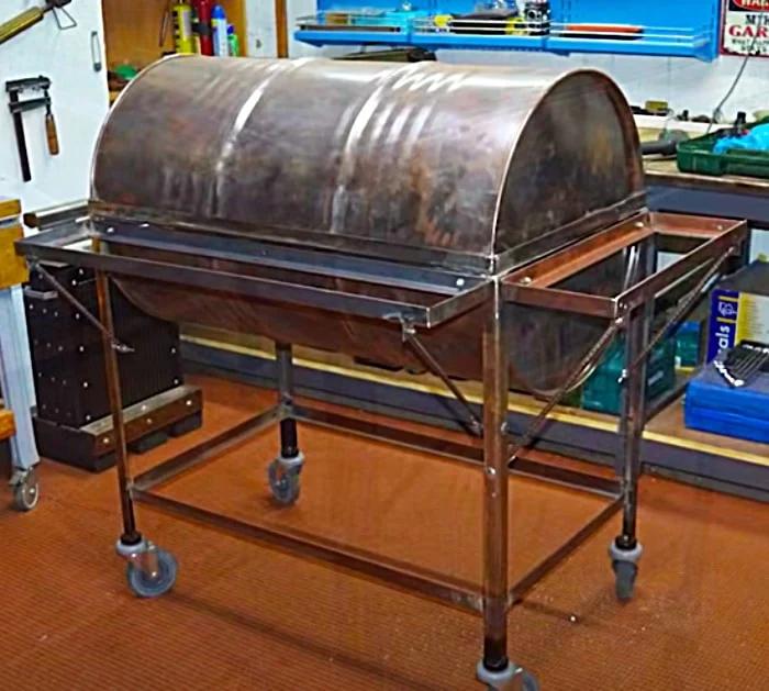 Set A Cut Metal Barrel Into A Metal Frame To Make A Standing Barbecue Pit With Castor Wheels