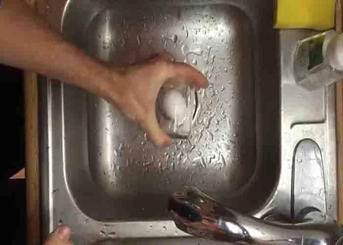 Shaking the glass with hard boiled egg and water hard