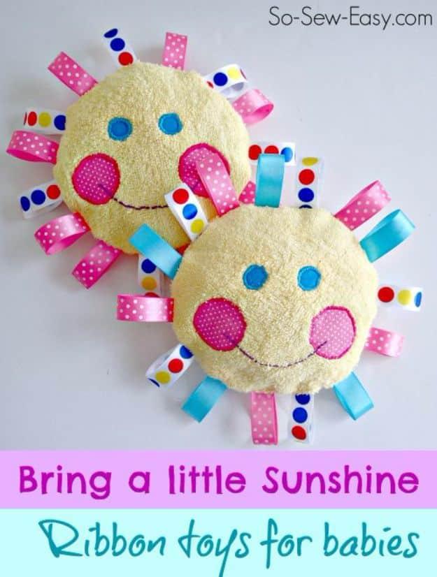 Handmade baby toys graphic showing two round yellow terry faces edged with ribbon loops and applique eyes