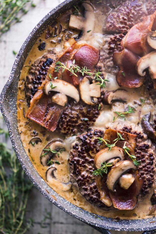 Chopped steak patties simmered in a bacon and wild mushroom cream gravy with fresh thyme leaves scattered over