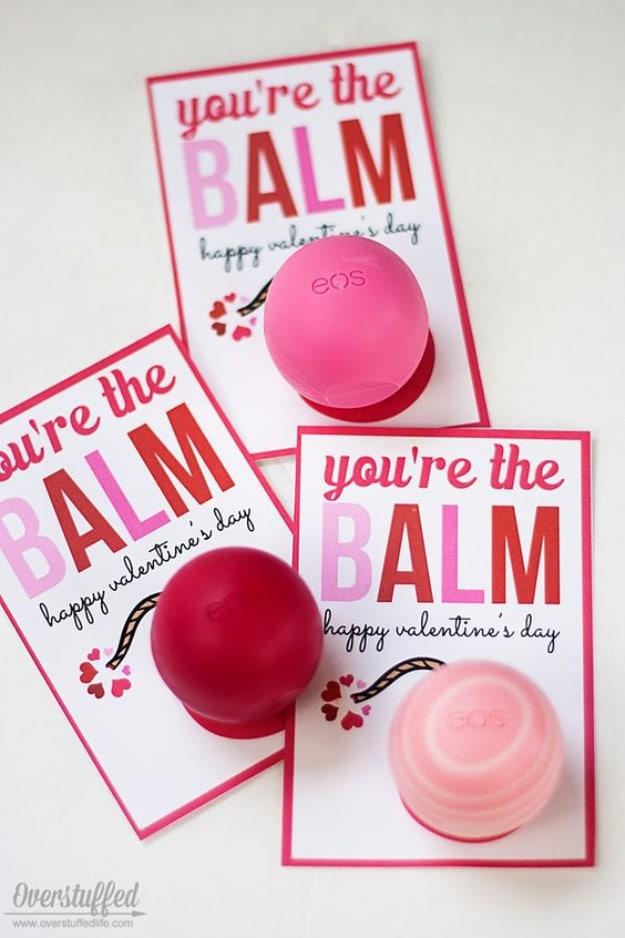 You're the Balm printable Valentine card holding a round pink EOS lip balm pushed through a cut slot