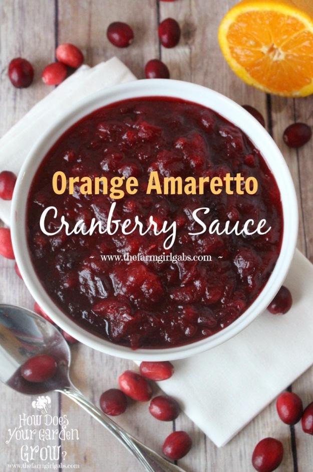Orange amaretto cranberry sauce in a glass bowl, deep red and glossy, with strips of orange zest on top