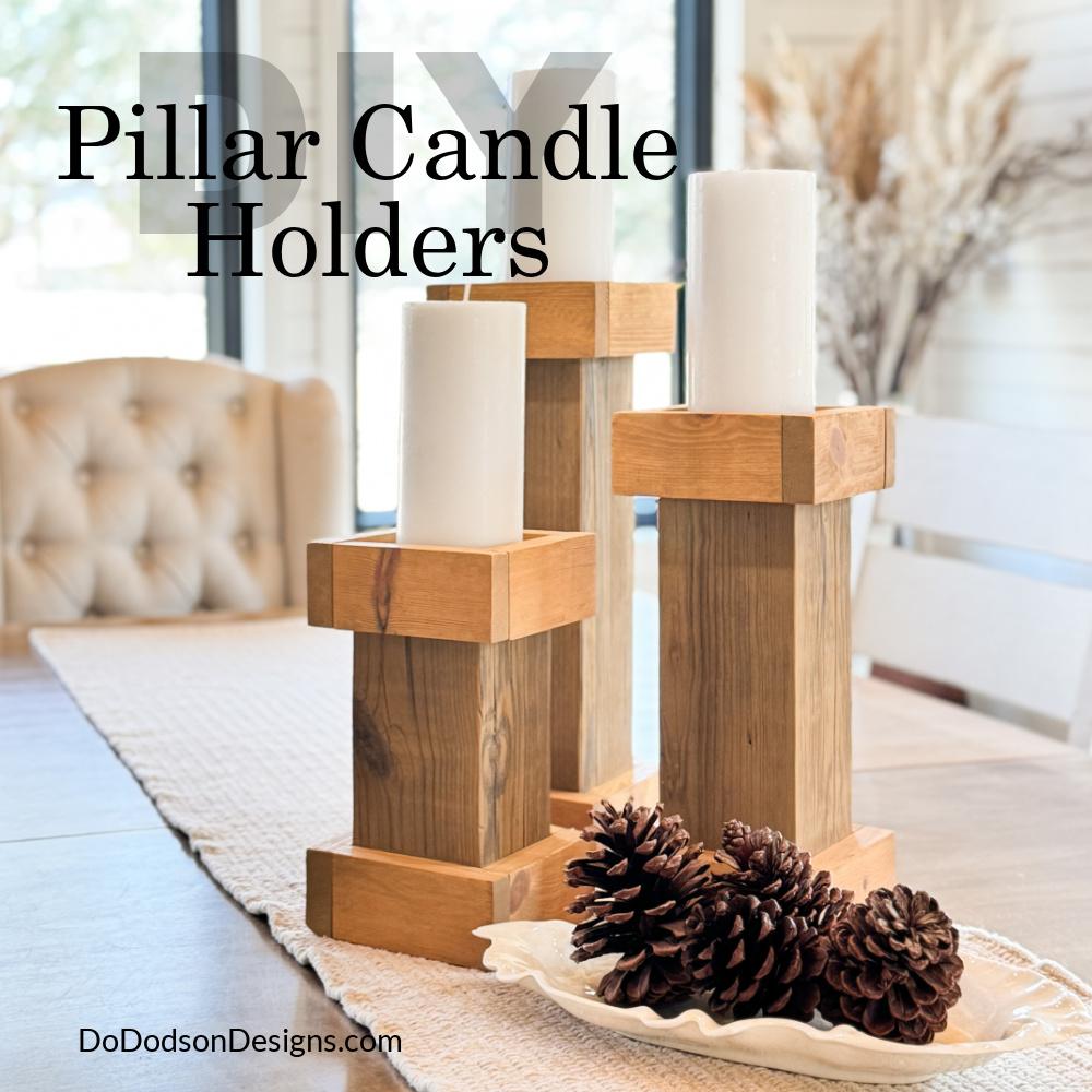 Three graduated wood pillar candle holders with white candles on a table runner beside a dish of pine cones, with title text