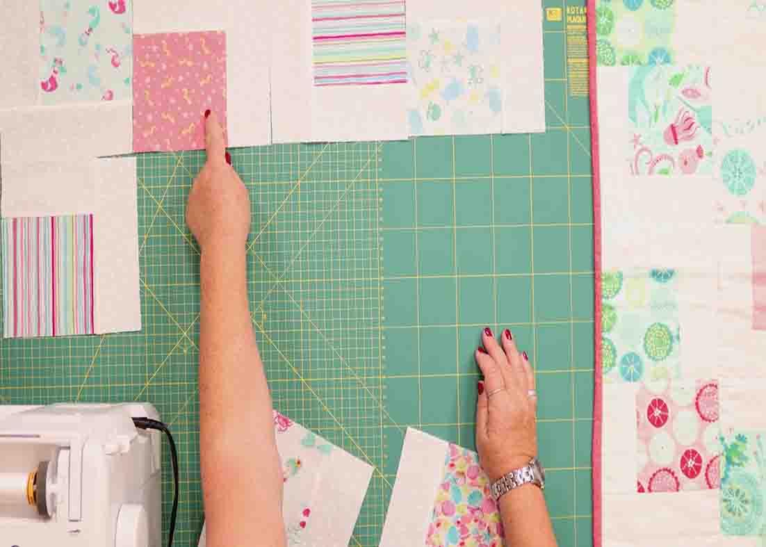 Laying out the blocks to make the tumbling charms quilt