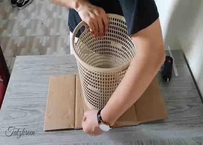 Tracing the laundry basket to make the DIY plastic bottle caps basket