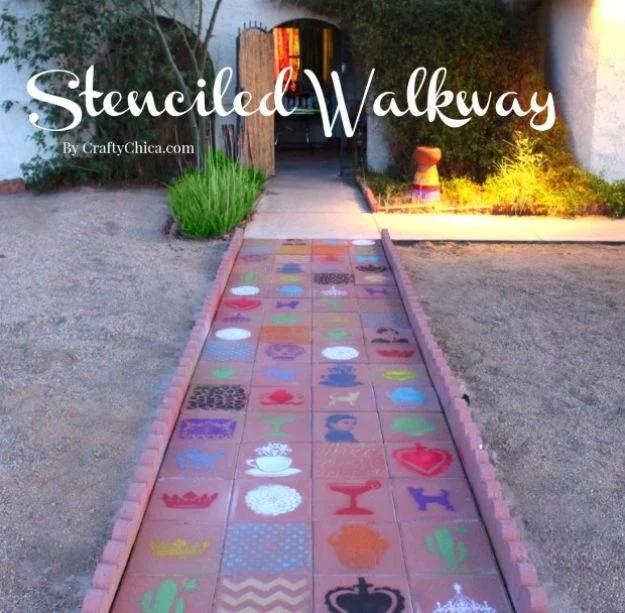 Paver walkway stencilled in bright multicolored talavera style patterns leading to an arched doorway