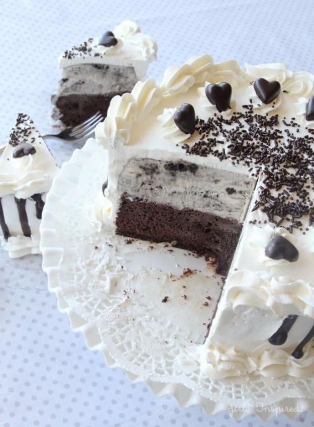 Homemade Oreo ice cream birthday cake with whipped topping, chocolate sprinkles and one slice cut out