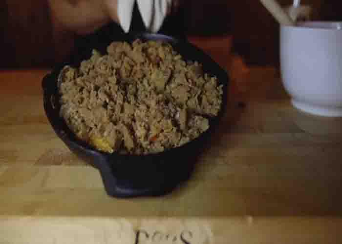 Cooking the bourbon peach cobbler in the smoker grill