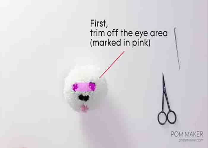 Trimming off and shaping the pom pom dog