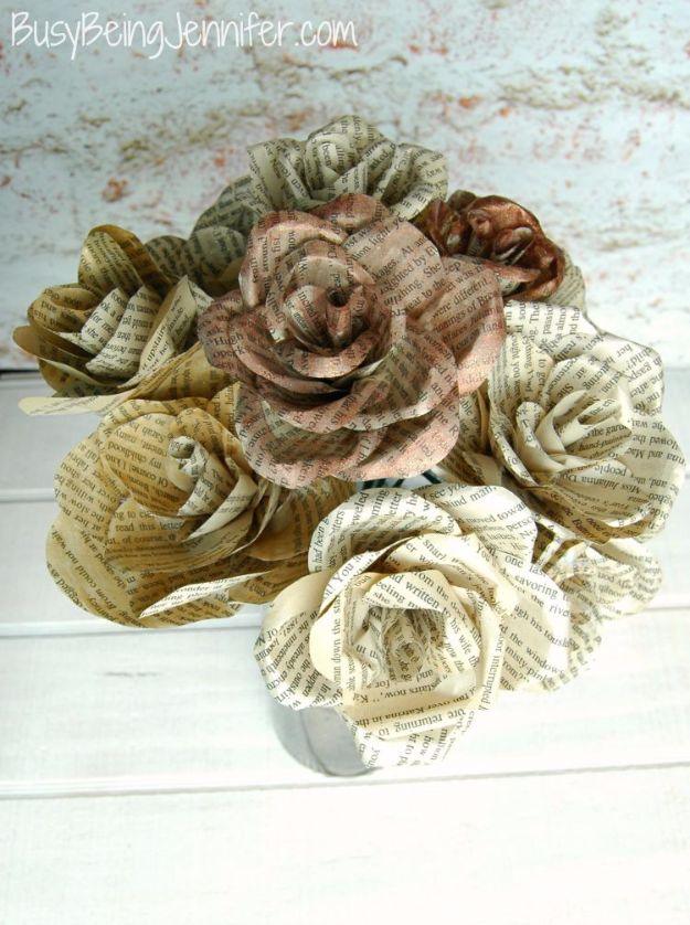 DIY book page flowers, cream and painted brown book page paper roses piled on a white washed wood table