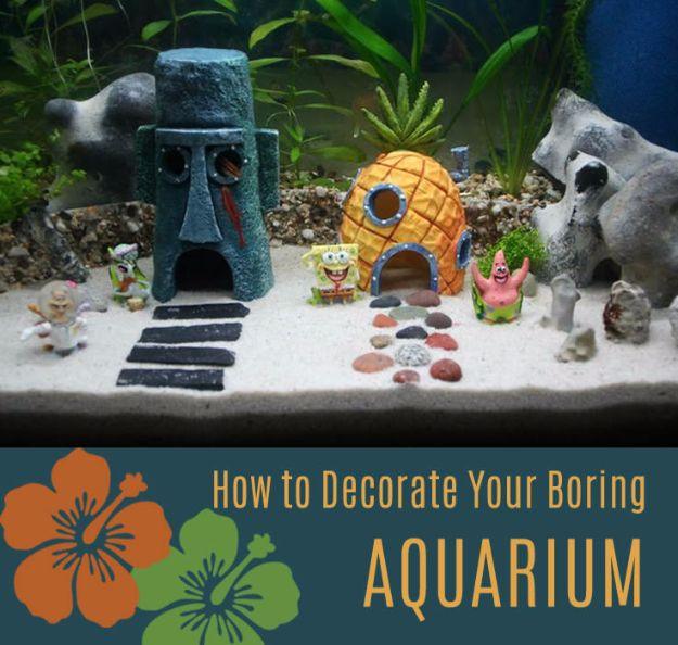 DIY aquarium decorated with a stone head, a pineapple house and cartoon figures on white sand under green plants