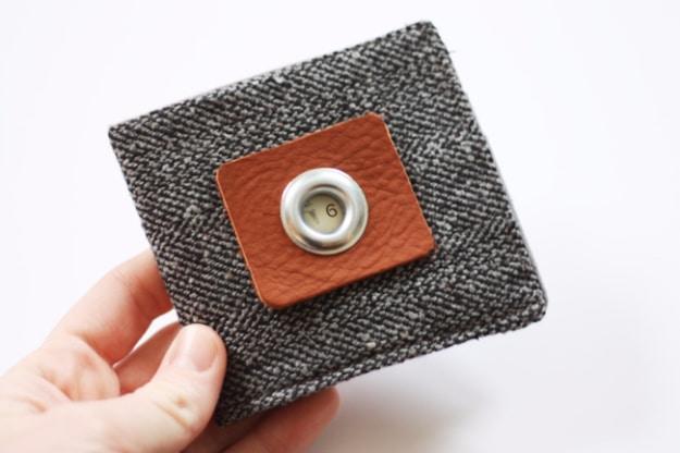 A bifold wallet sewn from two cotton prints, lying open with a card in one slot, one of the best things to sell on Etsy
