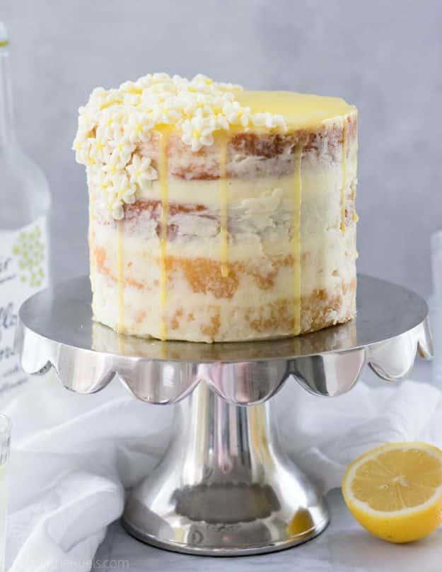 Lemon elderflower cake with floral buttercream and candied lemon on top, an elegant celebration bake