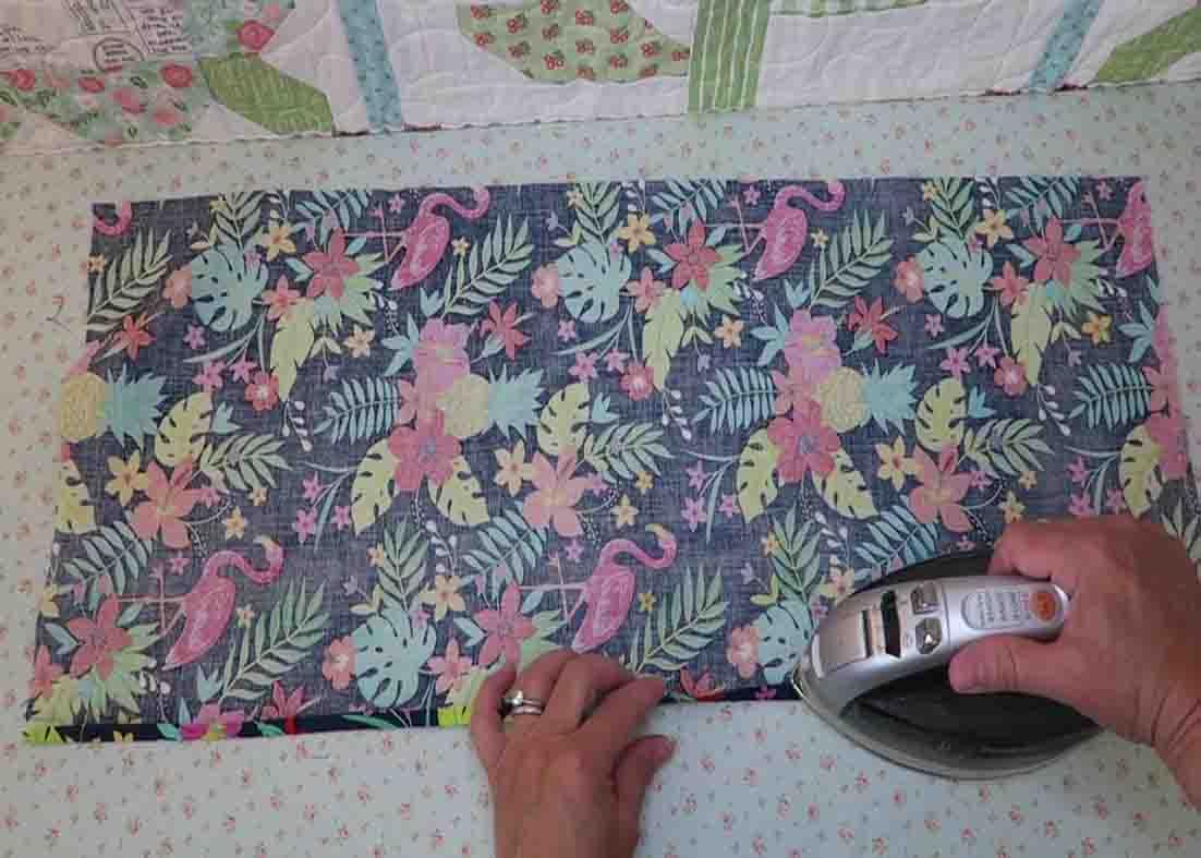 Pressing the edges of the fabric