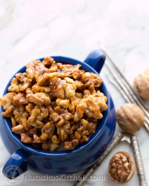 Glossy candied walnuts cooling after five minutes in a skillet, an easy sweet snack and salad topping recipe