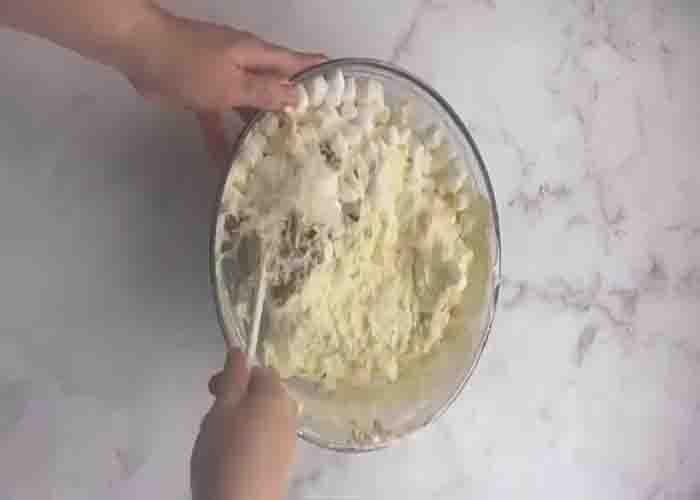 Adding the shredded coconut and pecans to the pina colada stuff