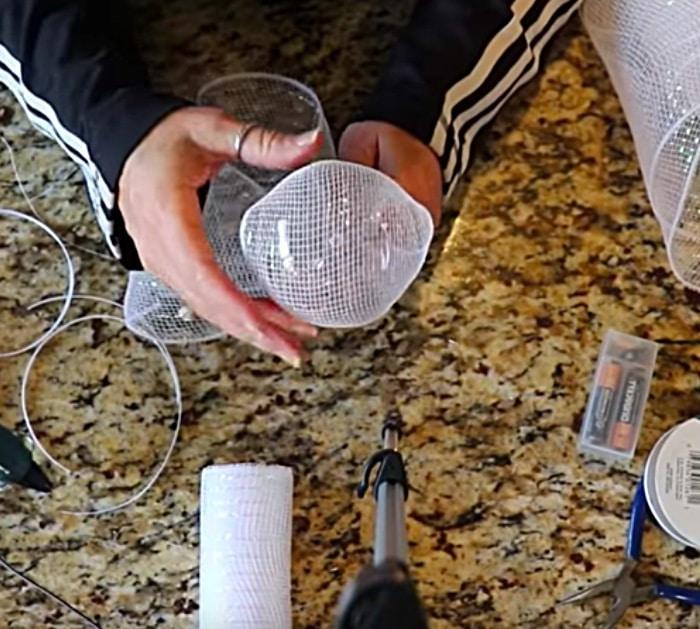 Learn to make Dollar Tree DIY Ribbon Mesh Angel Using A Trash Basket and Dollar Tree Ribbon