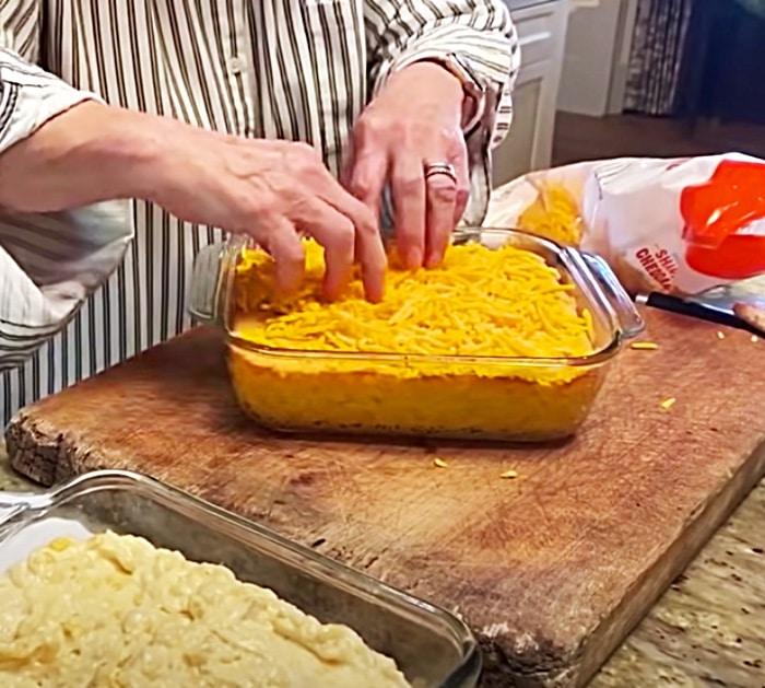 Top Paula Deen's corn casserole recipe with grated sharp cheddar cheese