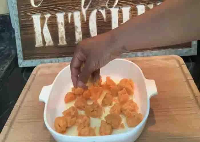 Adding the canned yams to the casserole dish
