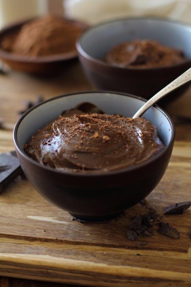 Paleo chocolate mousse made with avocado, served in small glasses with grated chocolate, a healthy dessert idea