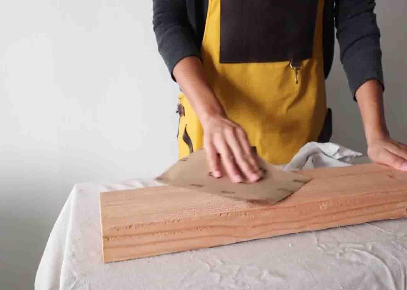 Sanding down the wood plank