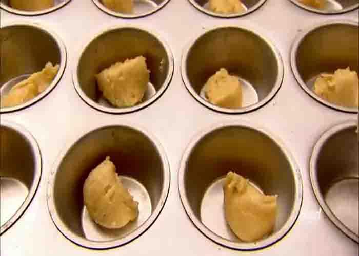 Dividing the sticky bun batter to the muffin cups