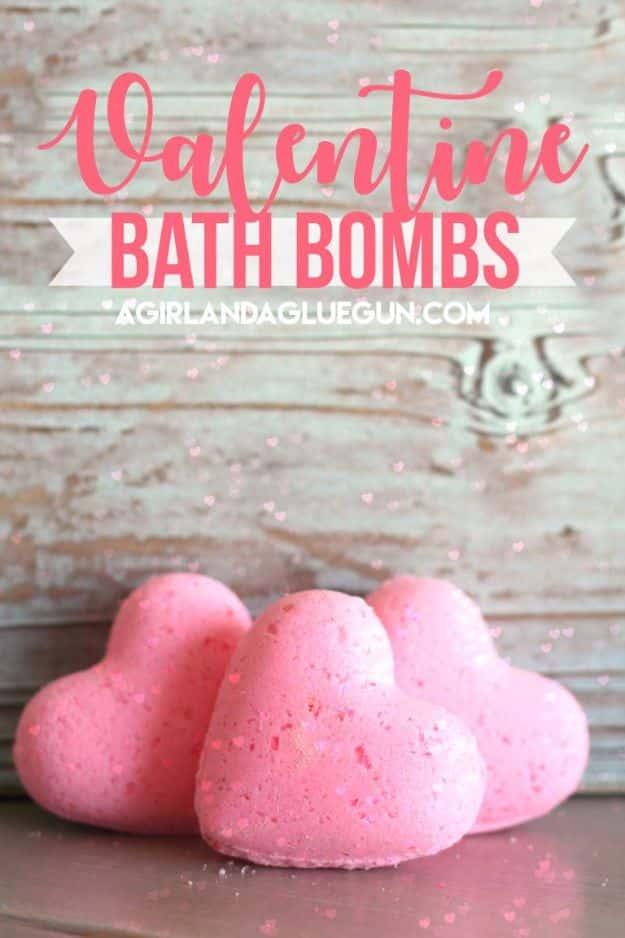 Pink heart shaped bath bombs with confetti sprinkles on a towel, a handmade Valentine's gift for her